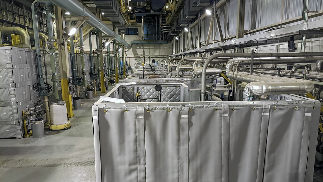 Soundproofing curtains installed on industrial air compressors